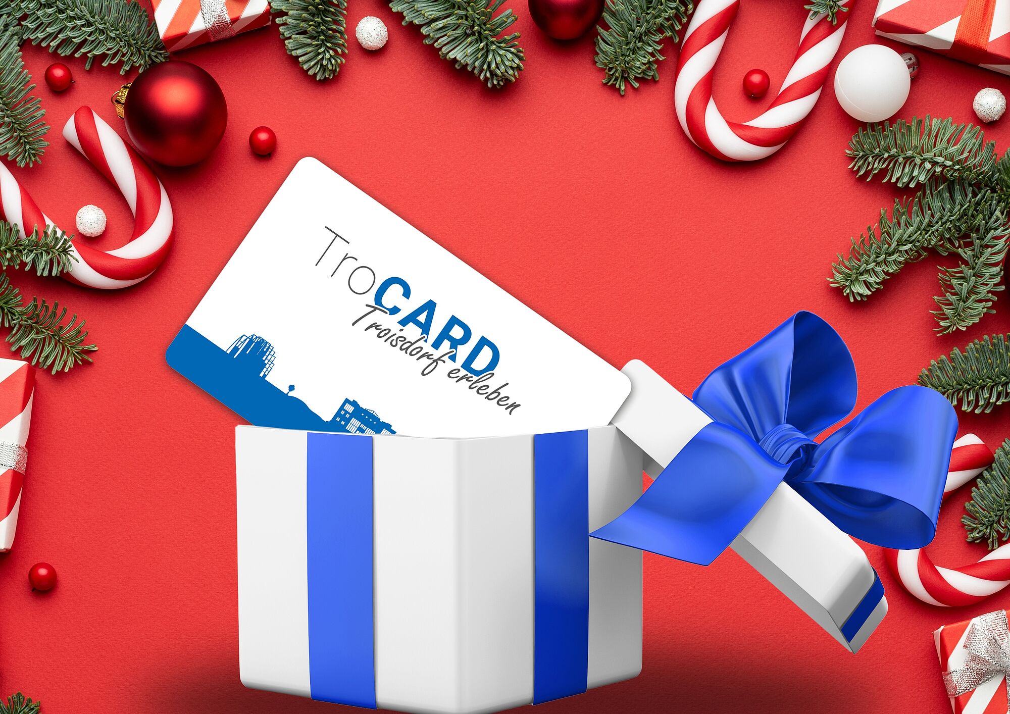 TroCARD in Geschenkebox TroCARD in Geschenkebox vor weihnachtlicher roter Kulisse