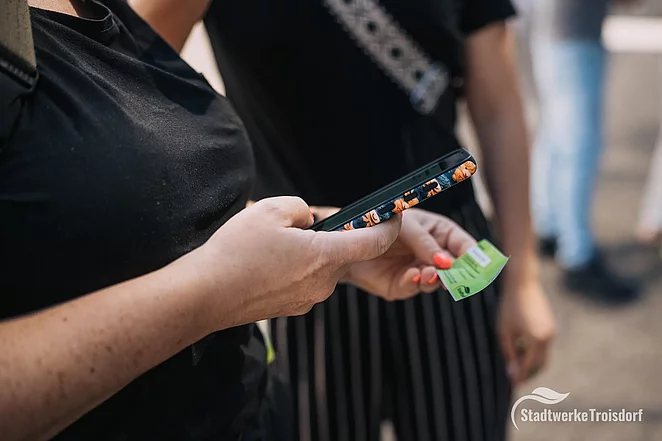 Frau scannt Förder.Ei-Code mit dem Handy